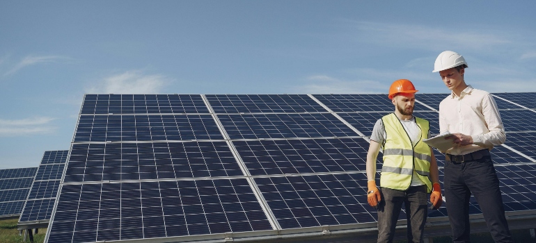 Electricians inspecting solar panels.