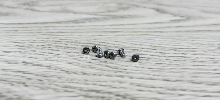 Some screws on a table representing How Regular Maintenance Ensures Optimal Performance of Solar Street Lights.