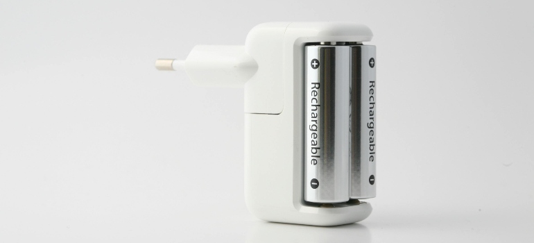A white power charger with two batteries.